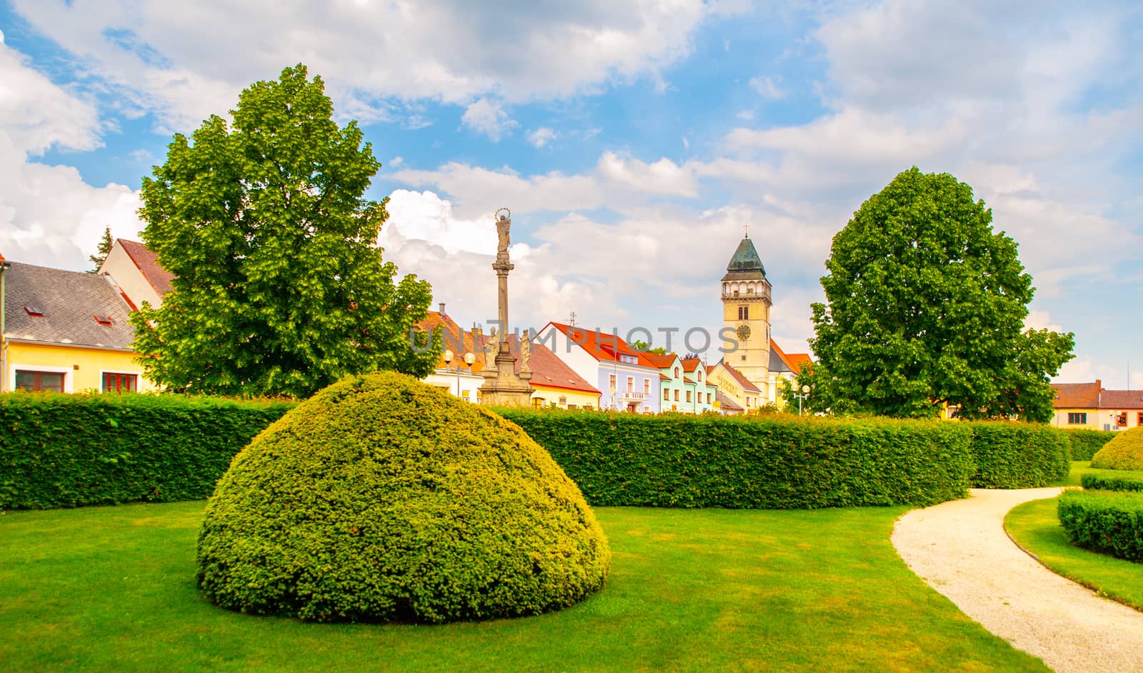 Town park greenery and church of Saint Lawrence in Dacice, Czech Republic.
