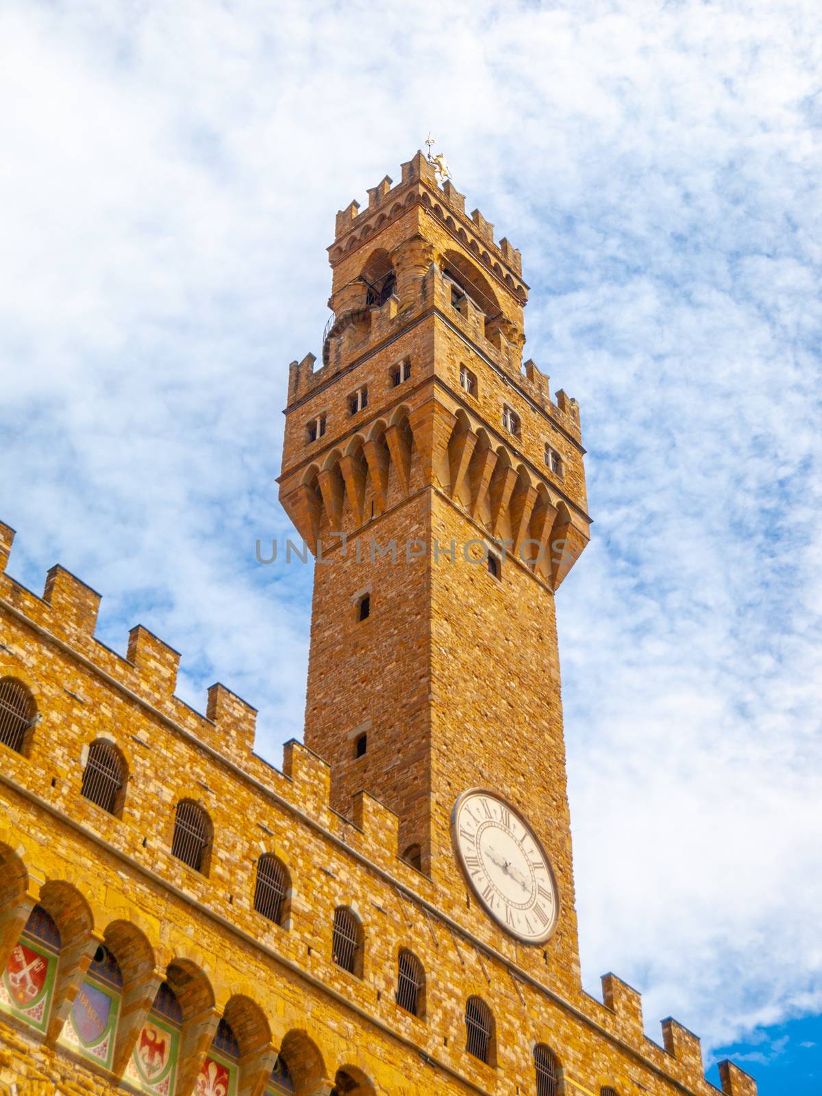 Bottom view of Pallazo Vecchio, Old Palace - Town Hall, with high bell tower, Piazza della Signoria, Florence, Tuscany, Italy.