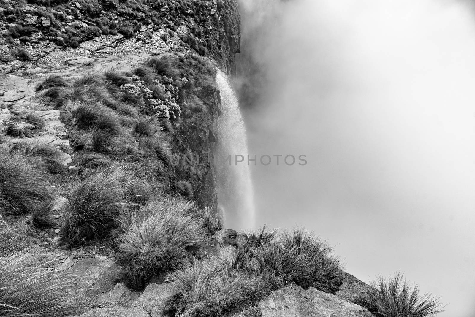 Monochrome view of the Tugela Falls, the second tallest waterfall on earth. The Tugela River plunges 948 m in five steps from the top of the Amphitheatre in the Drakensberg