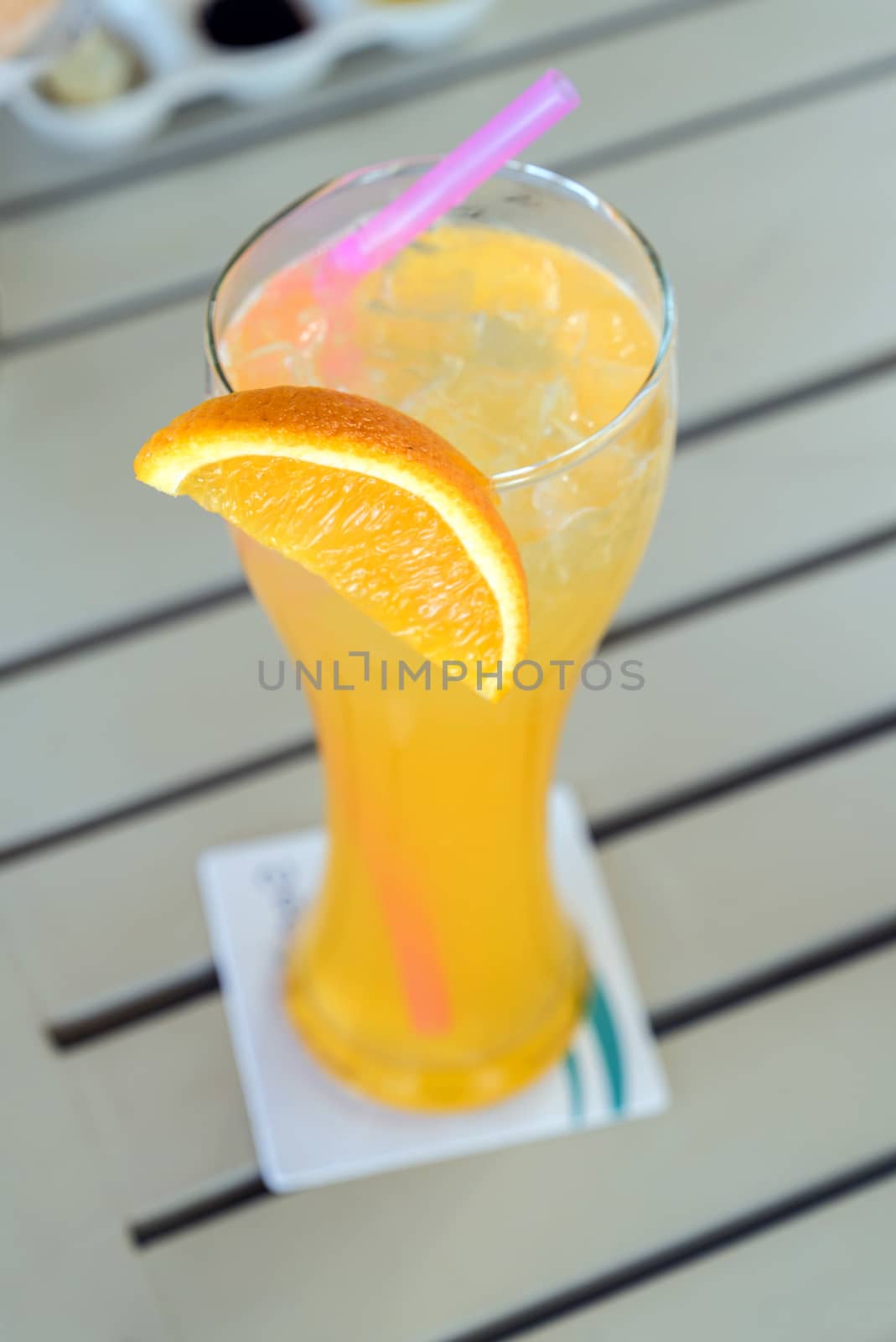 Orange juice from fresh orange in glass