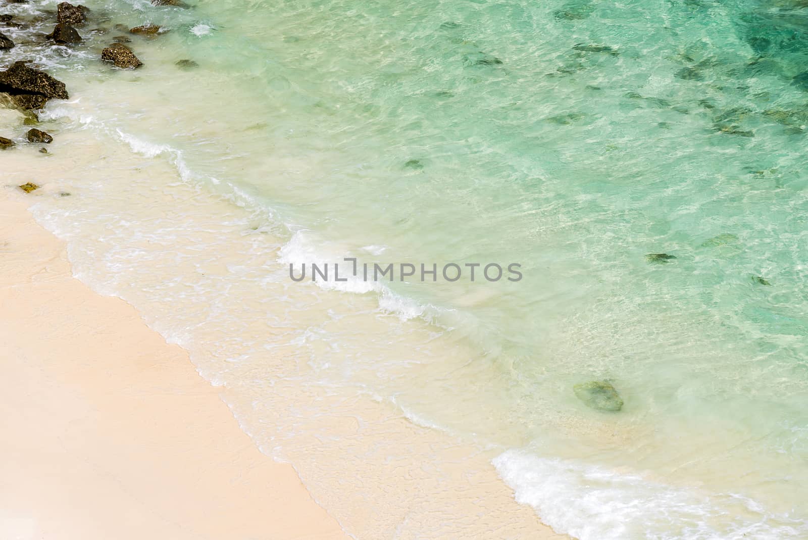 Soft wave of blue ocean on white sand beach at andaman sea, indian ocean, using as Seascape background 