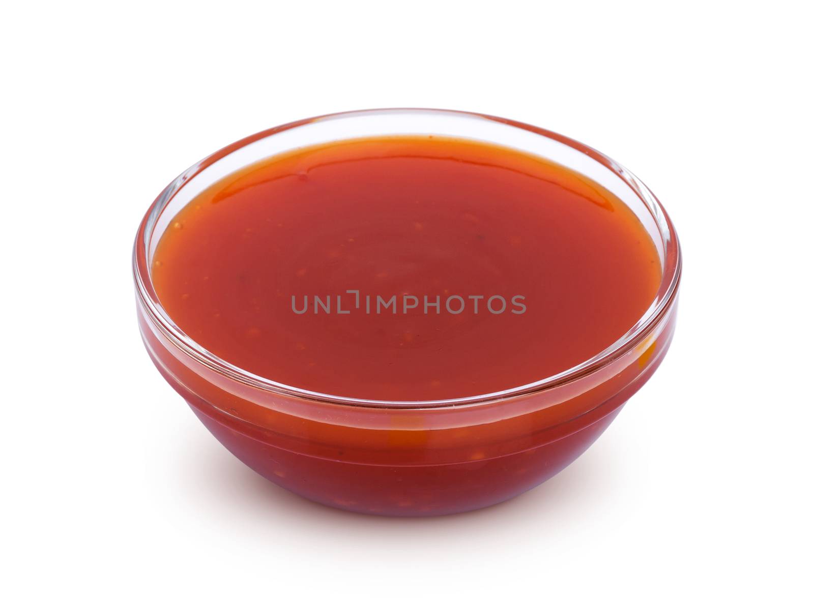 Hot chilli sauce in bowl isolated on white background with clipping path