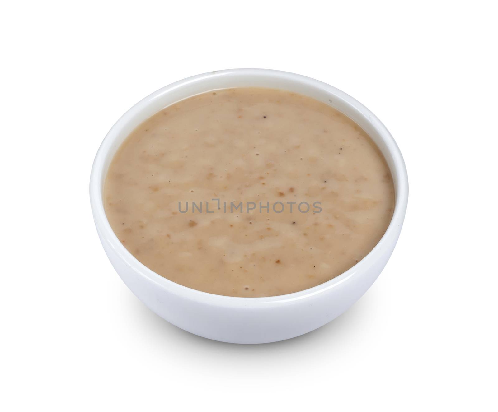 Sesame sauce. Tahini in bowl isolated on white background with clipping path