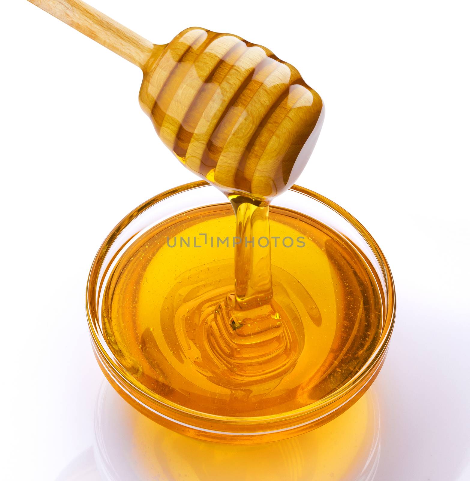 Honey stick and bowl of pouring honey isolated on white background by xamtiw