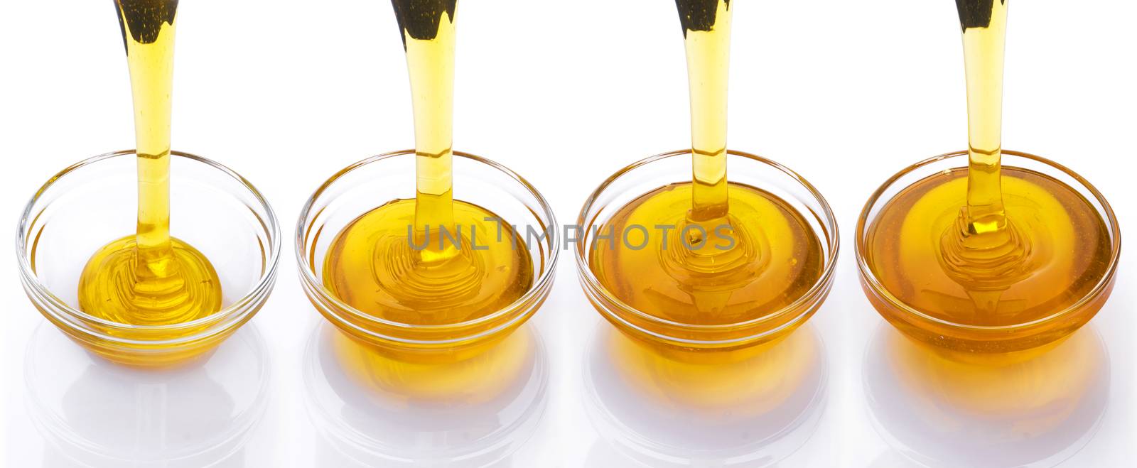 Pouring honey isolated on white background with clipping path