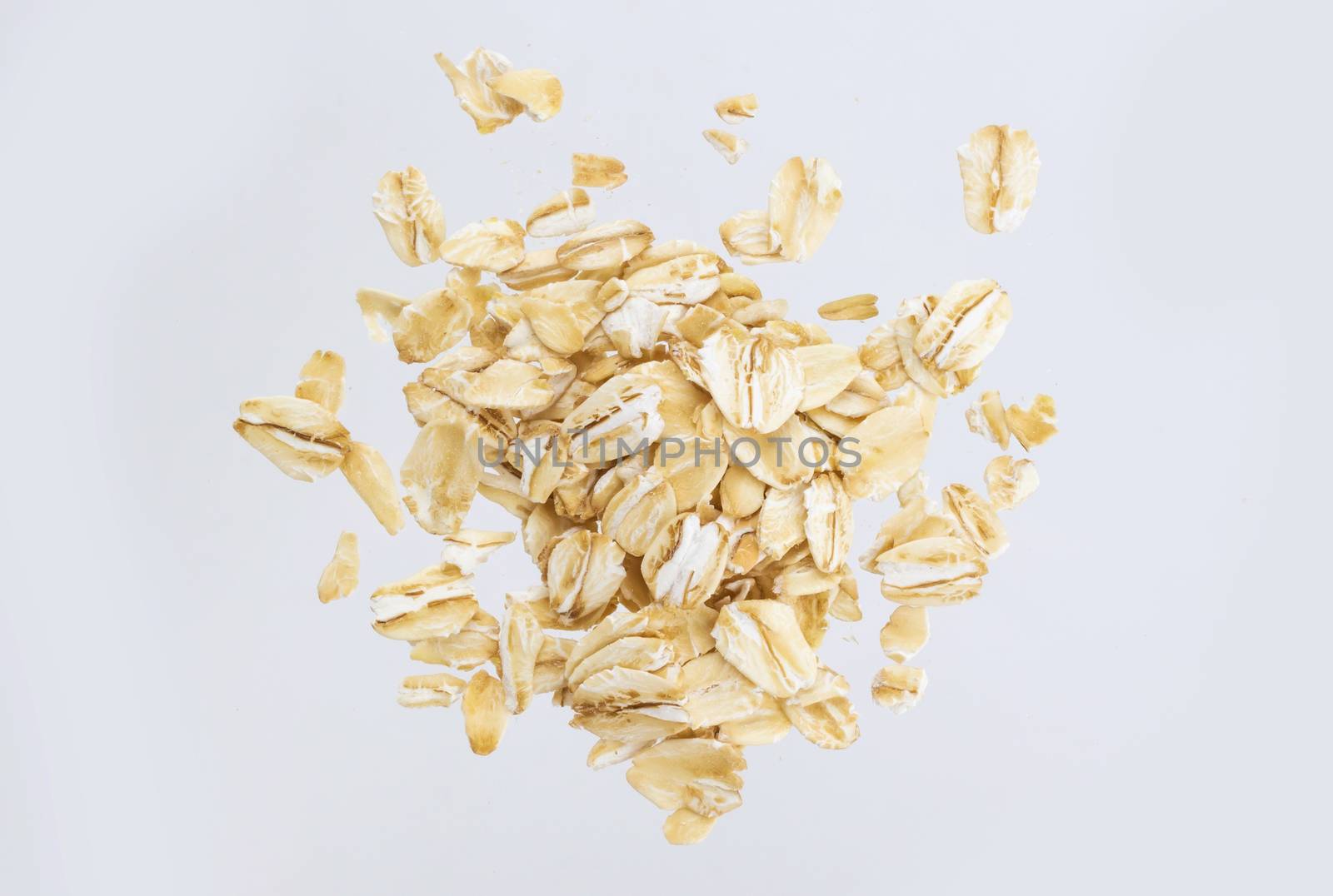 Oat flakes isolated on white background. Top view. Close up.