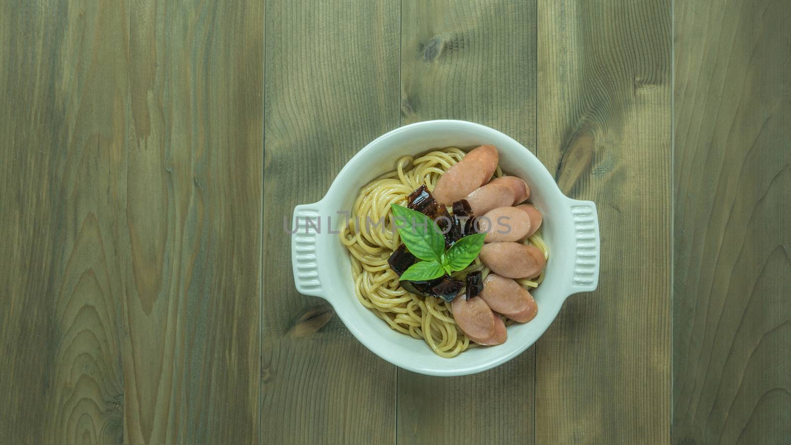 Spaghetti with sausage  and dried peppers , hot and spicy on wooden background, top view