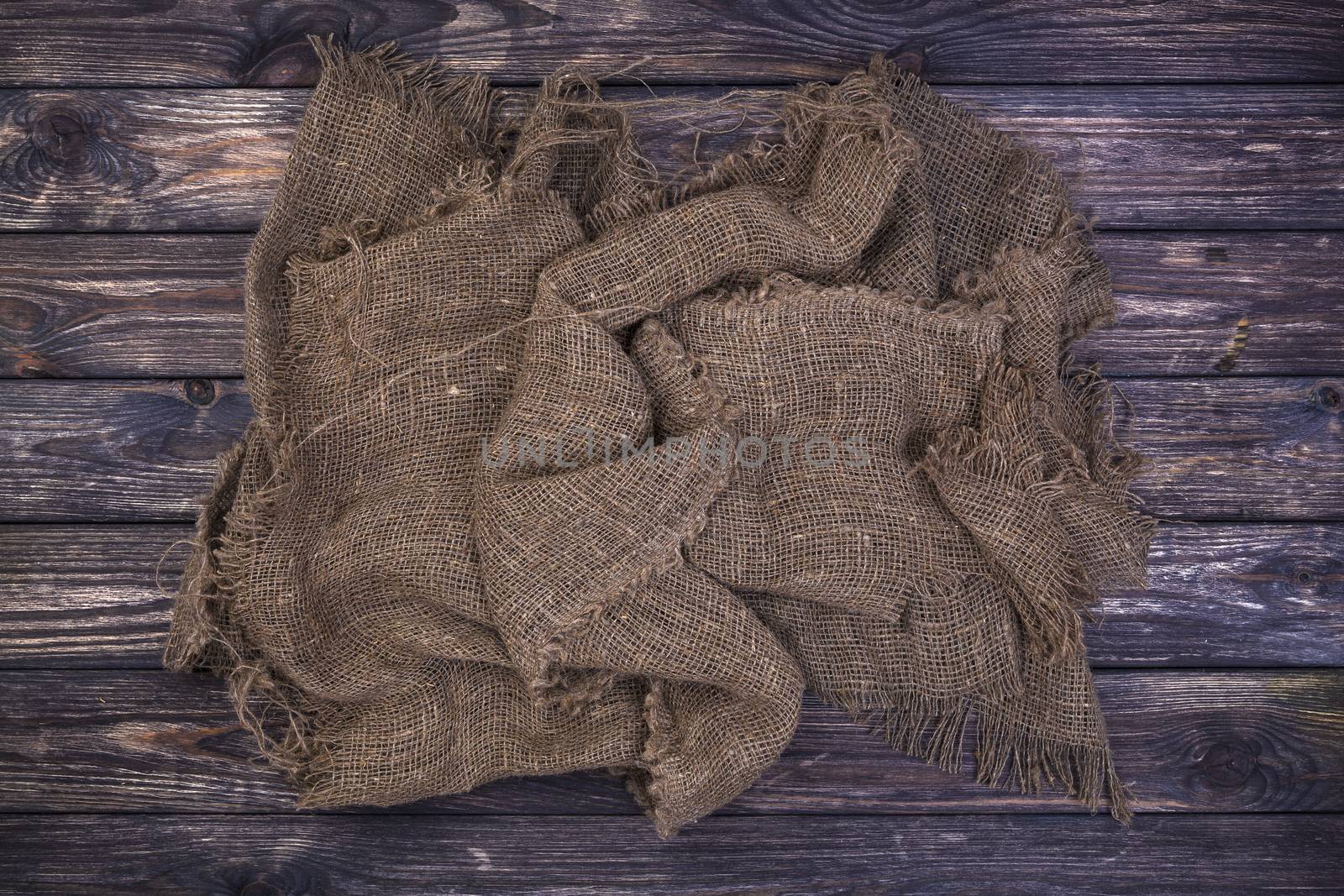 Burlap on black wooden background, top view by xamtiw