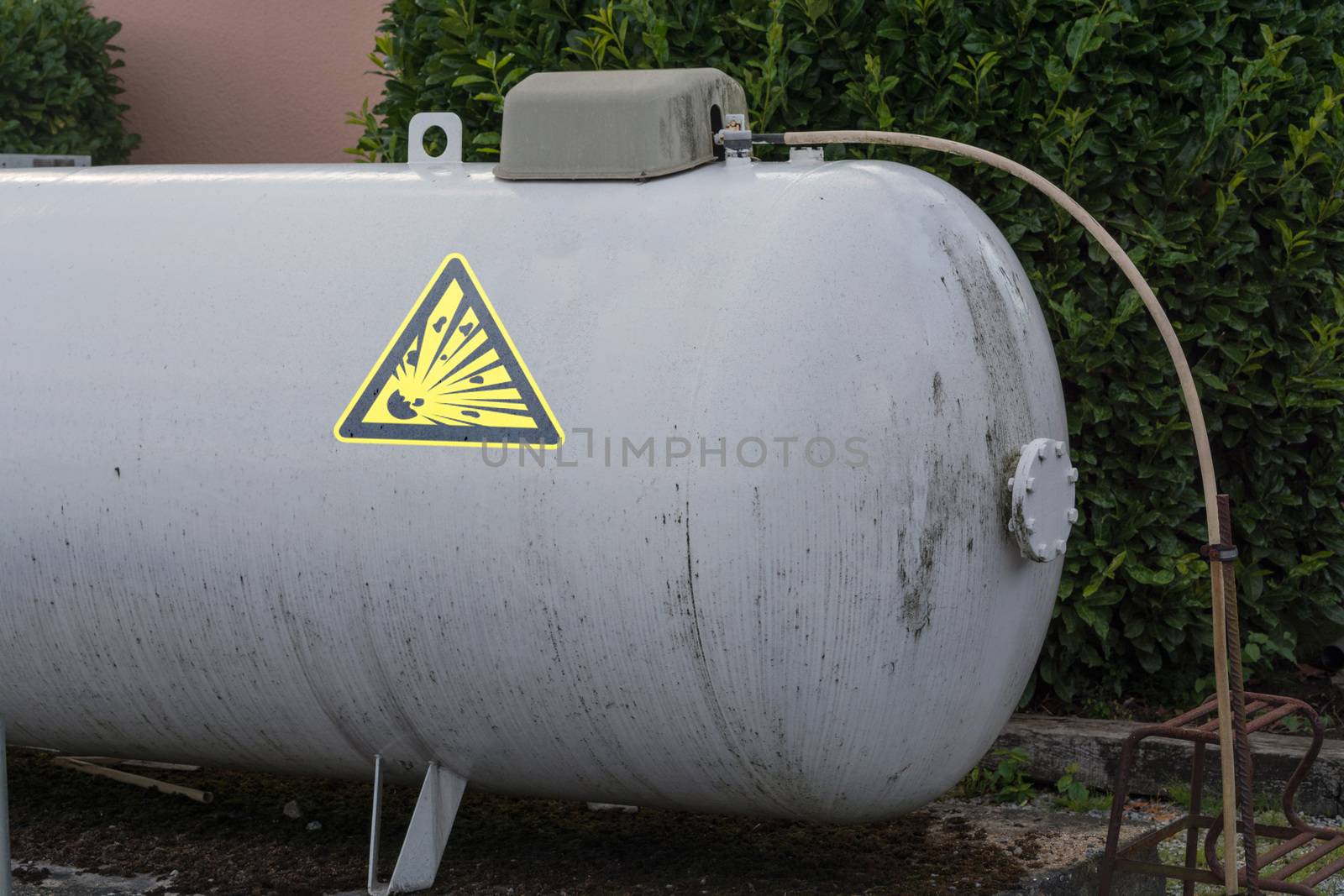 Large propane gas tank or liquid gas tank in a garden.