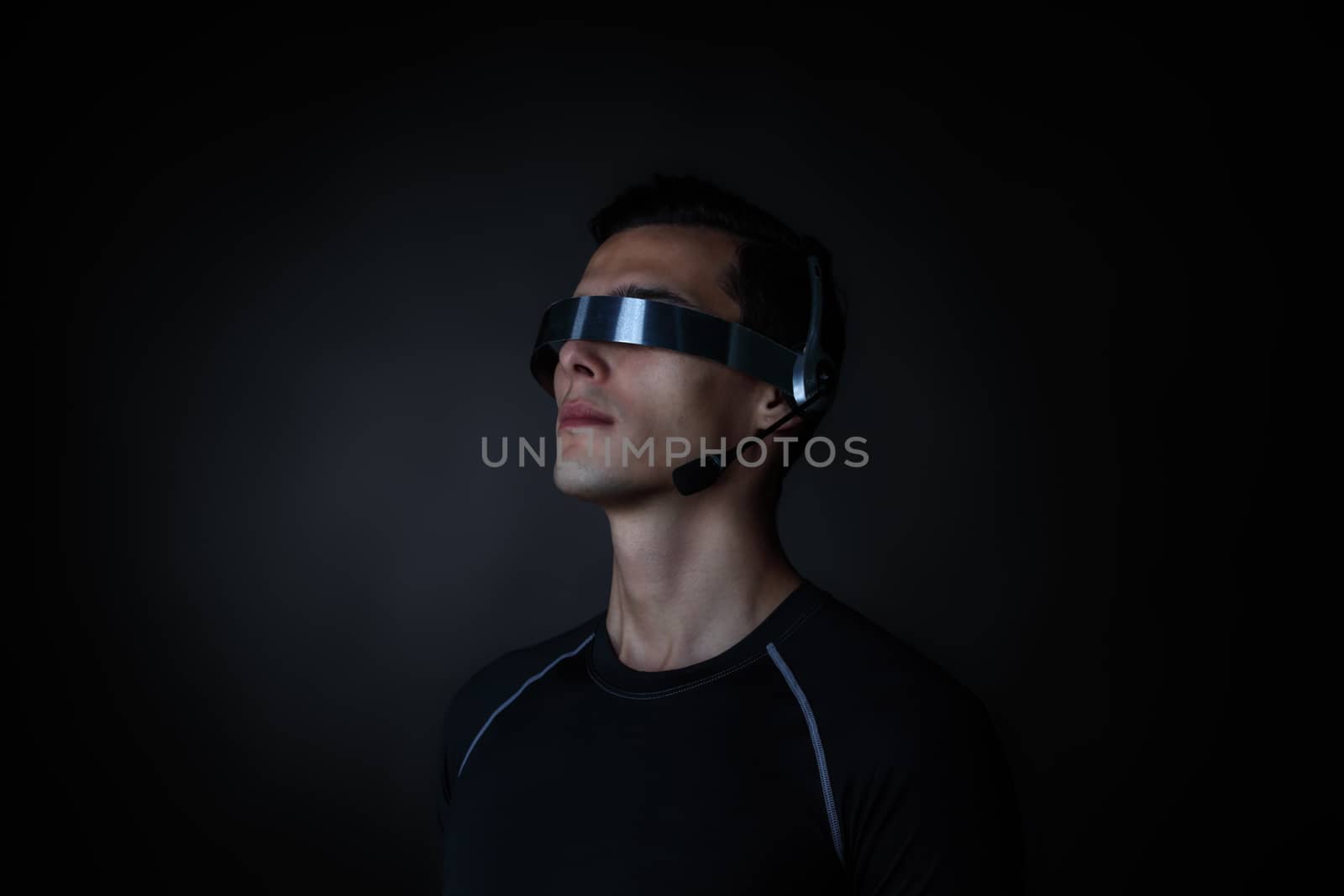 Man using futuristic VR goggles headset with microphone