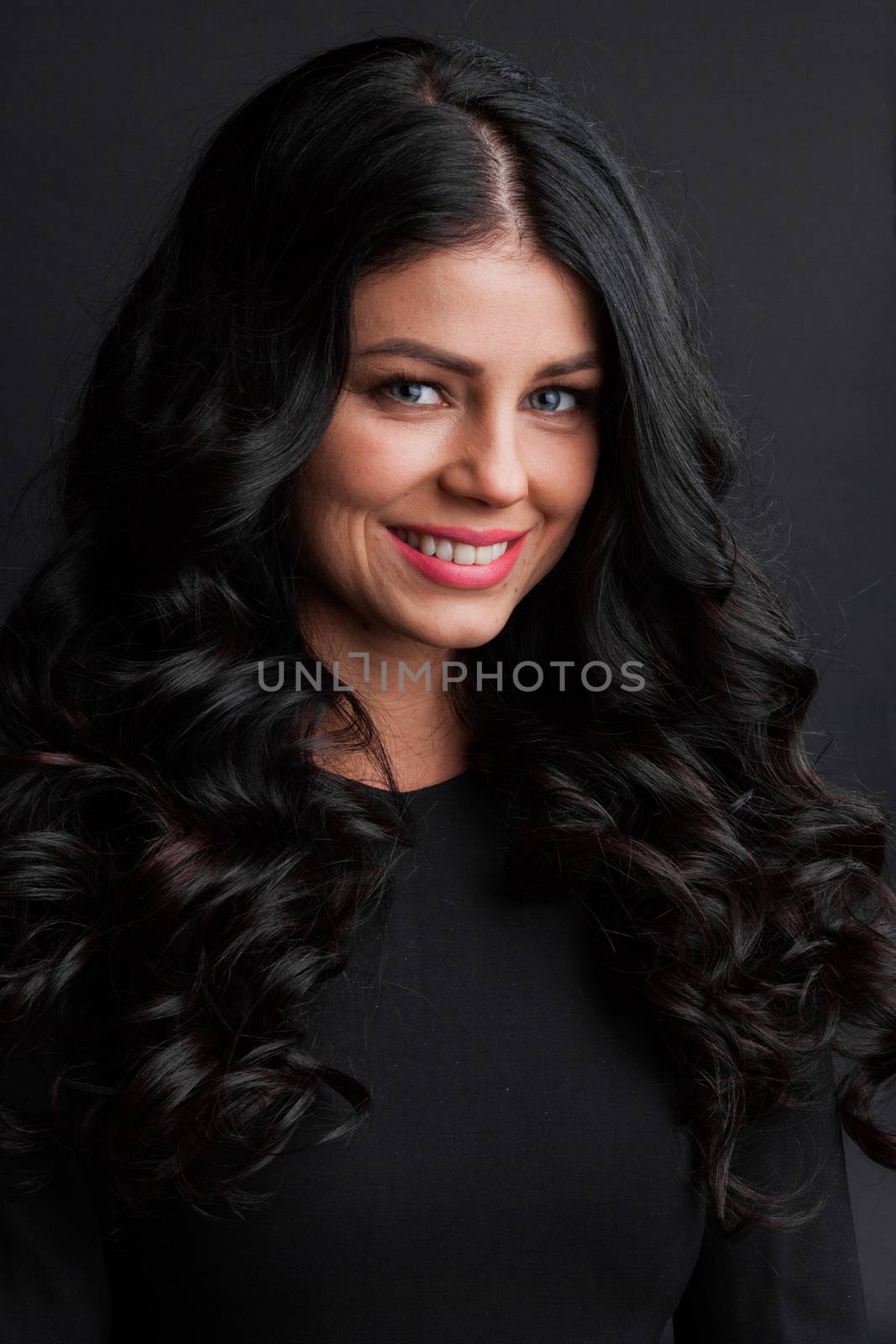 Portrait of gorgeous brunette with curly long hair