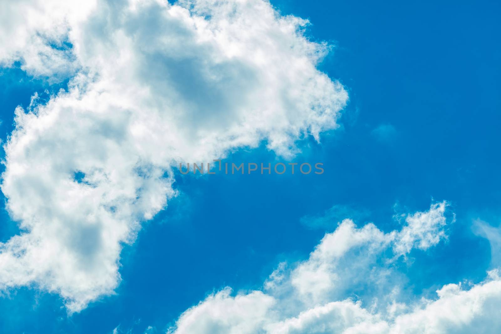 Deep blue bright sky with clouds background