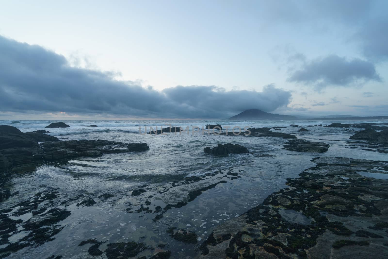 Mystical evening landscape. The ocean, sky and earth smoothly pass into each other, changing their usual colors for the magical colors