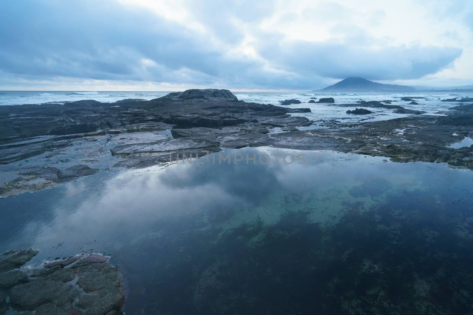 Mystical evening landscape. The ocean, sky and earth smoothly pass into each other, changing their usual colors for the magical colors