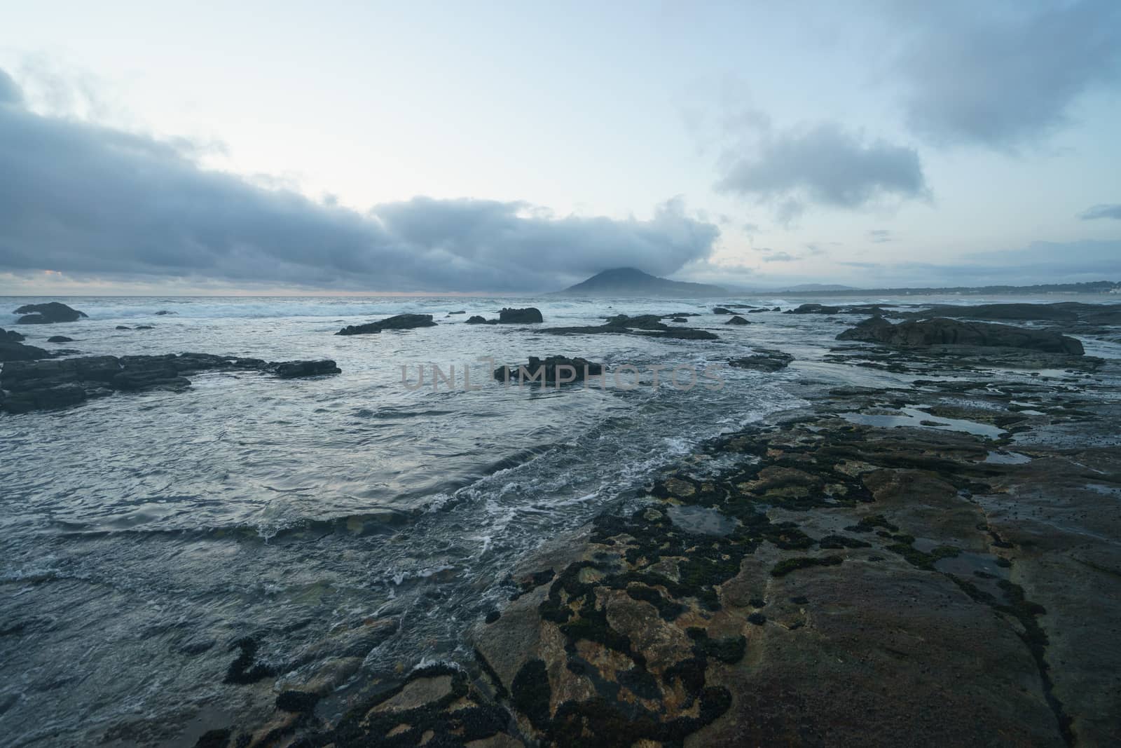 Mystical evening landscape. The ocean, sky and earth smoothly pass into each other, changing their usual colors for the magical colors