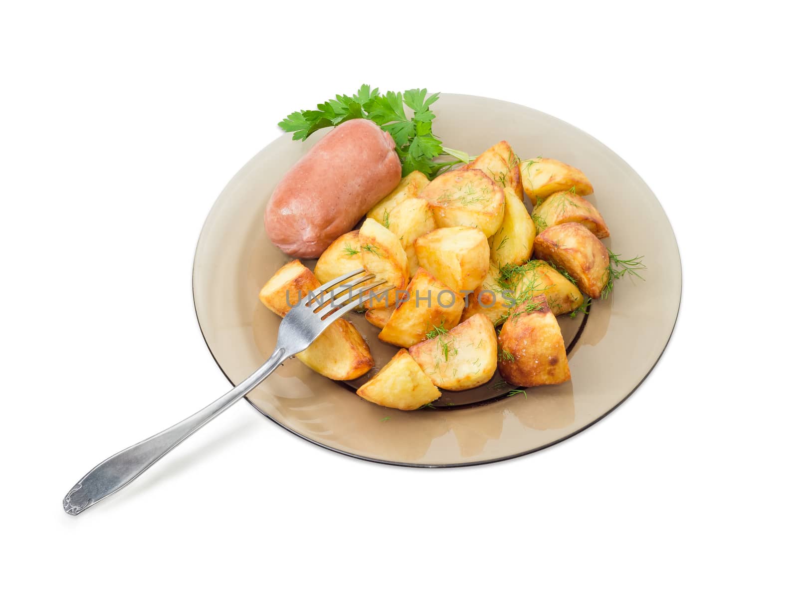 Serving of the country style fried potatoes sprinkled by chopped dill, fried wieners and twig of parsley on dark glass dish and fork on a light background
