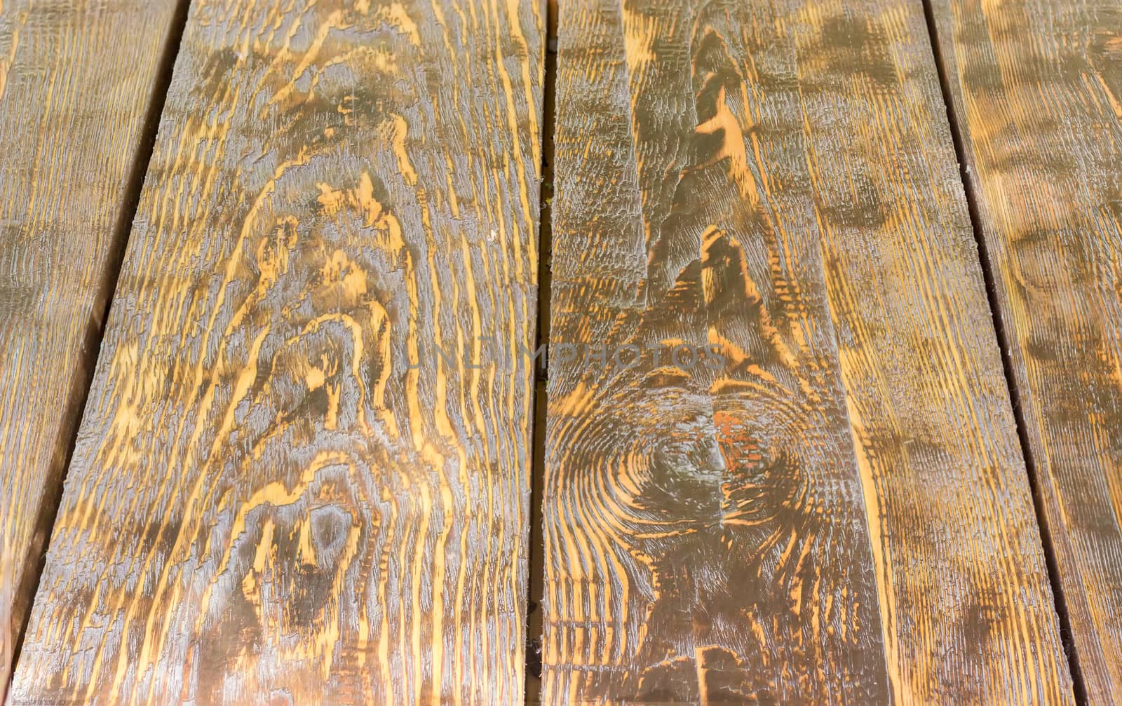 Background of a surface of the old wooden planks darkened with time
