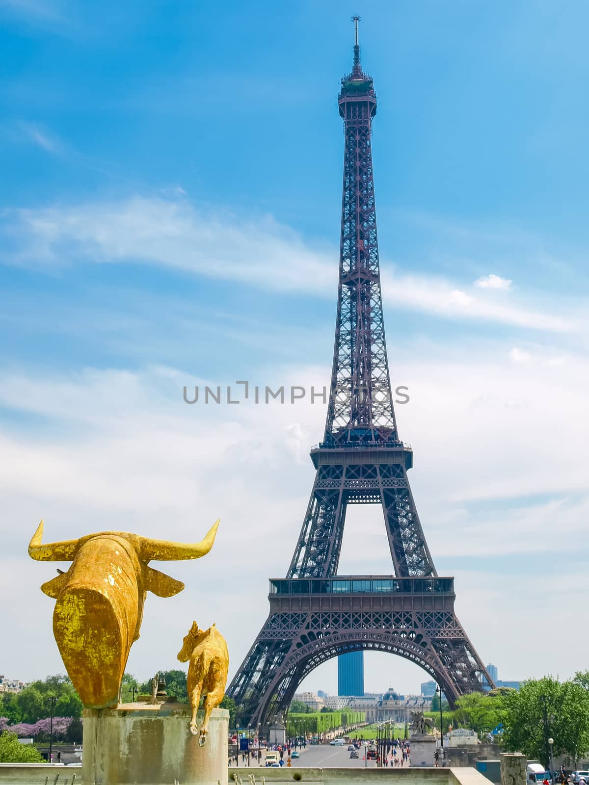View of the Eiffel Tower from the Trocadero Square with sculptures in the foreground in Paris.
