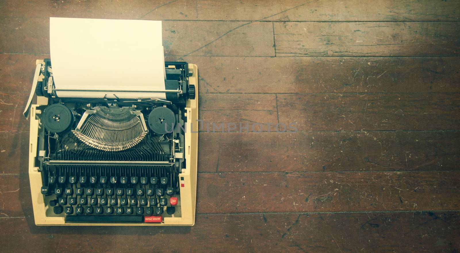 old retro   typewriter; on a wooden floor  by davincidig