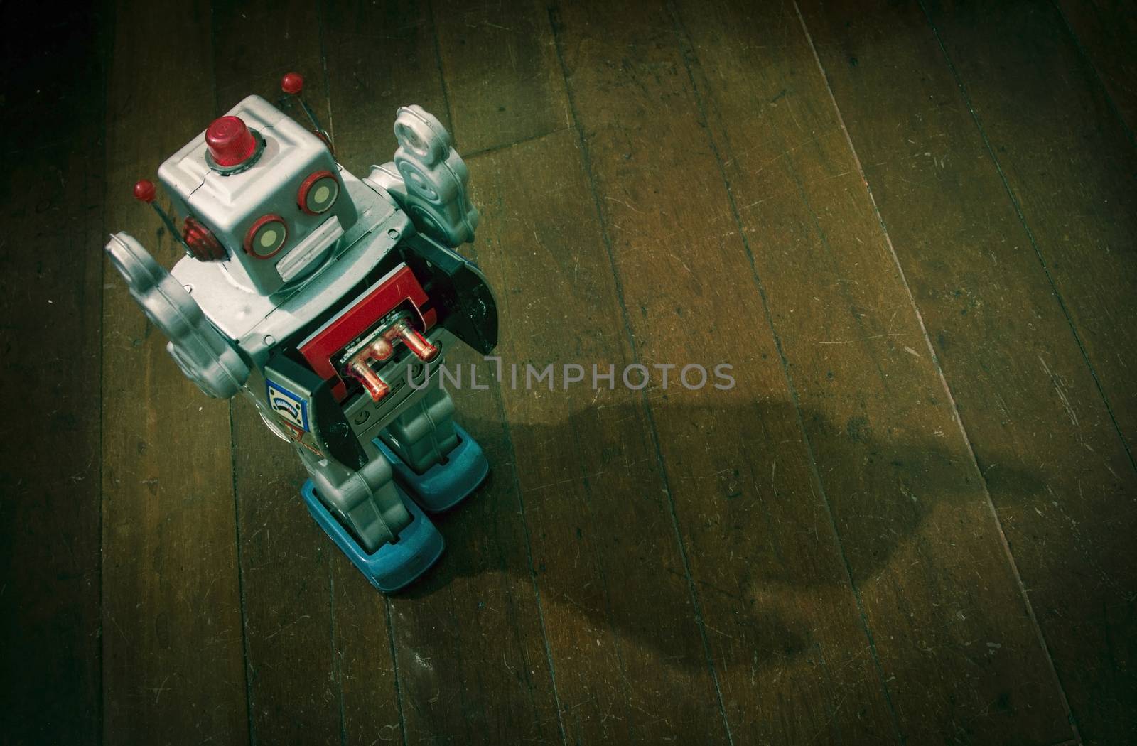 retro silver robot walking on old wooden floor