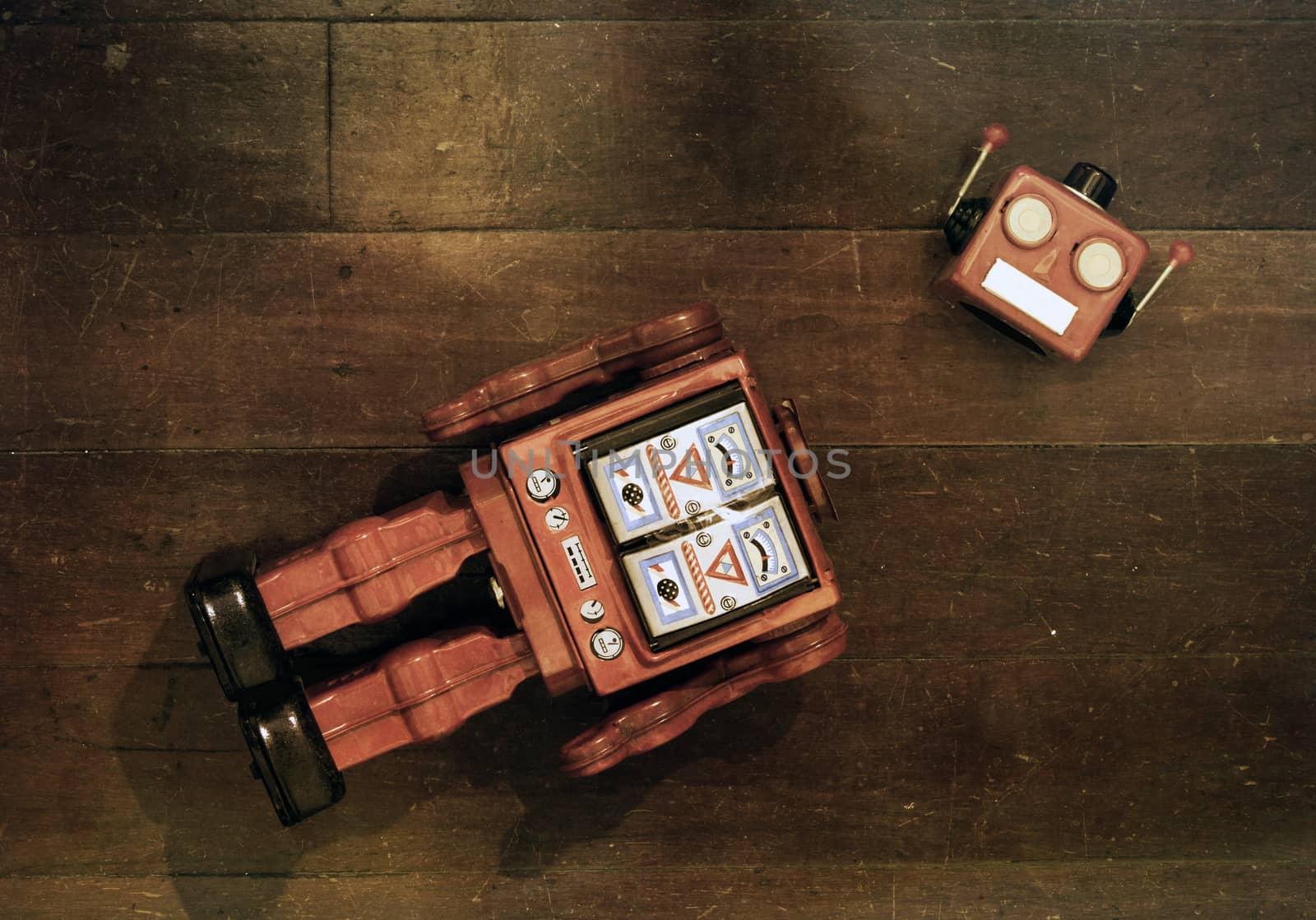 retro red robot has lost his head on a old wooden floor from above