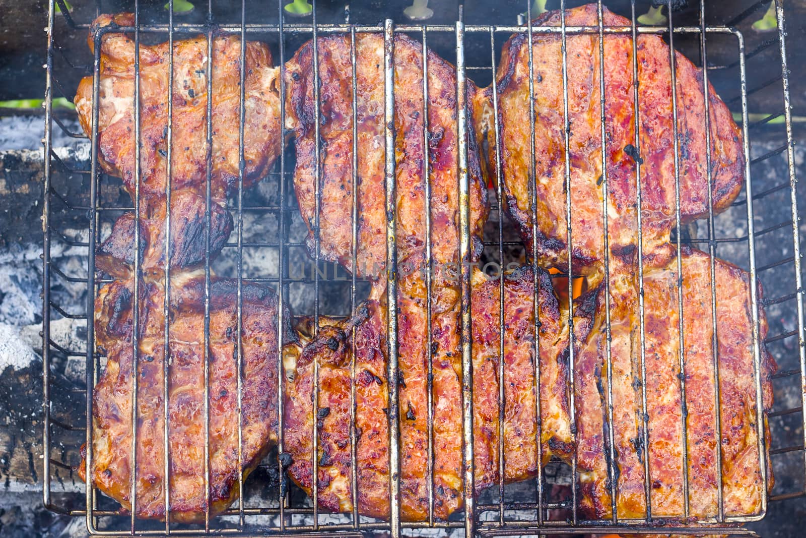 Meat fry on the grill fire. Barbecue fresh food delicious pork steak cooking
