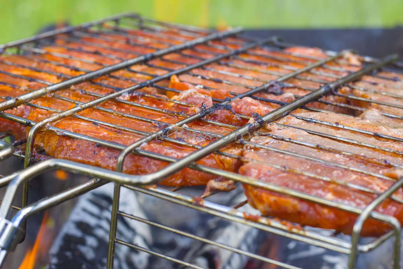 Meat steak fry on the grill fire. Barbecue fresh food delicious pork cooking on metal grid