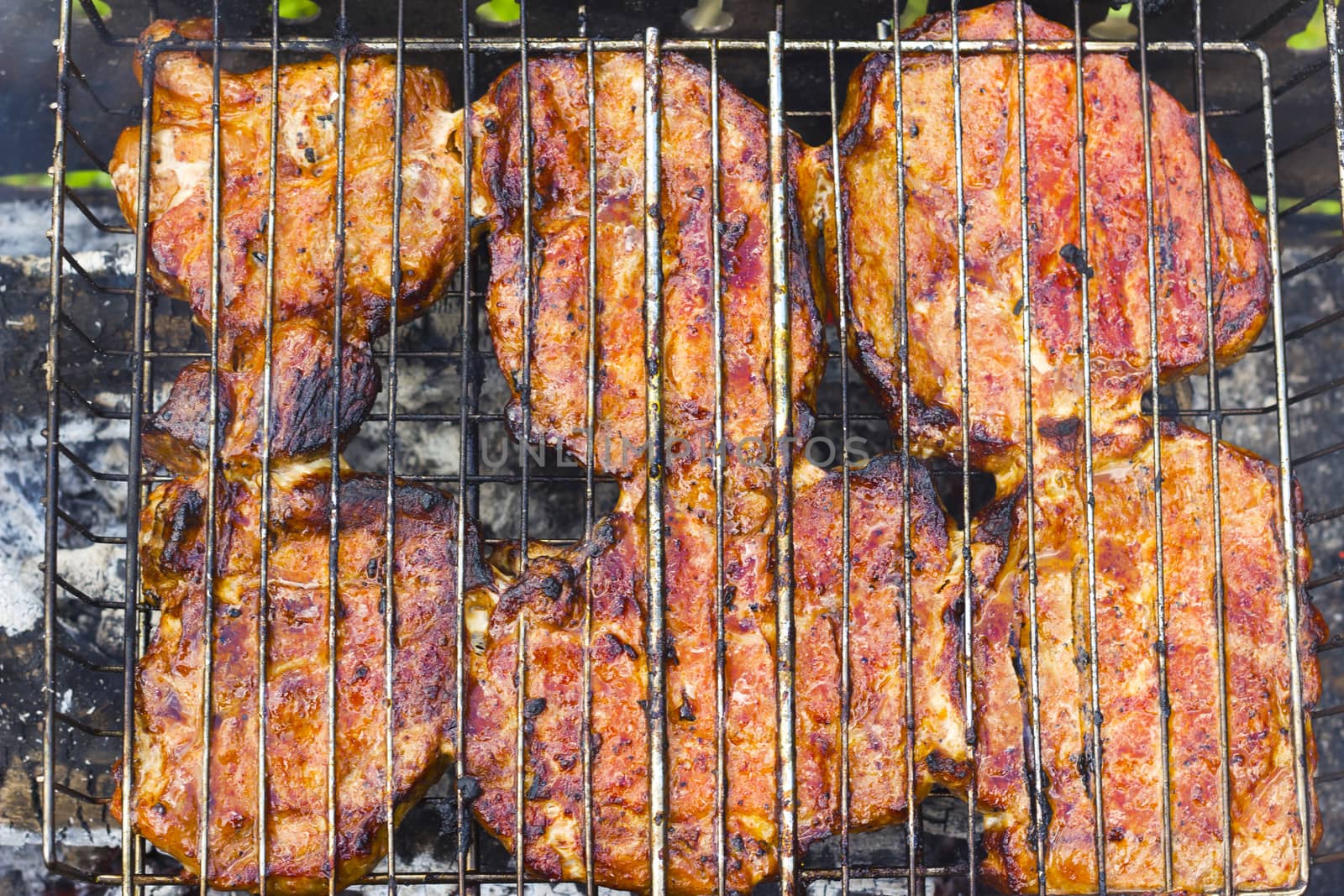 Ready to eat meat steak fry on the grill fire. Barbecue fresh food delicious pork cooking on metal grid