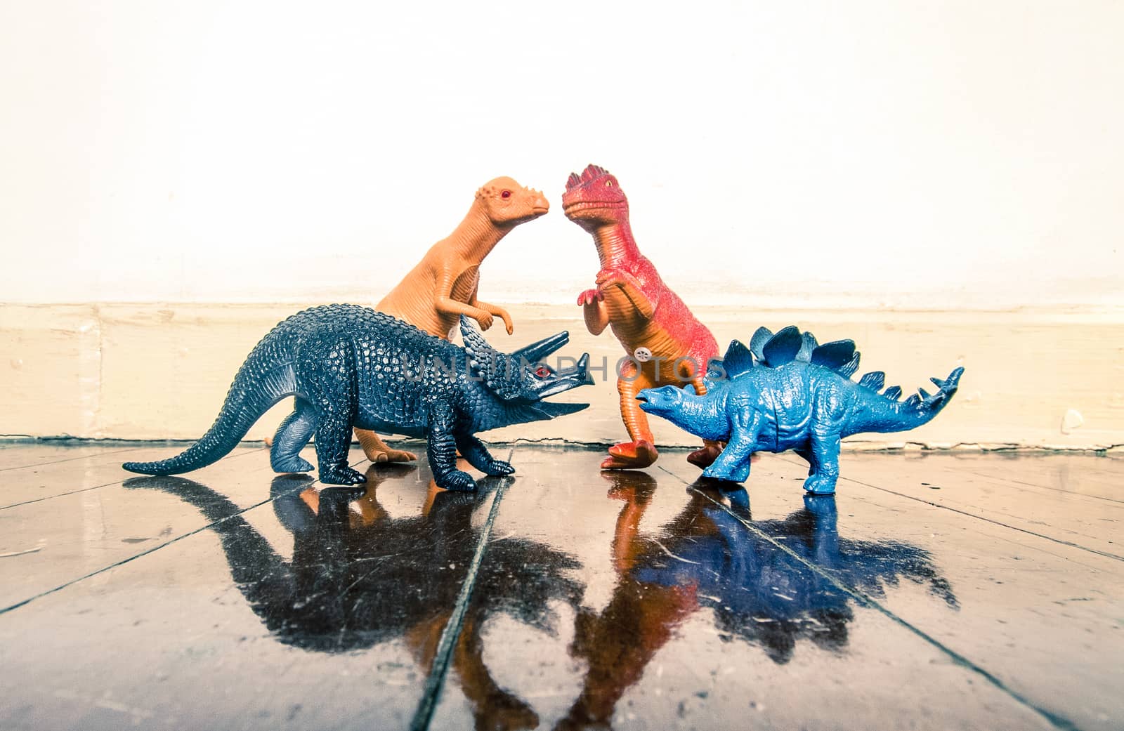 Tyrannosaurus rex and other dinosaurs on a wooden floor with reflection