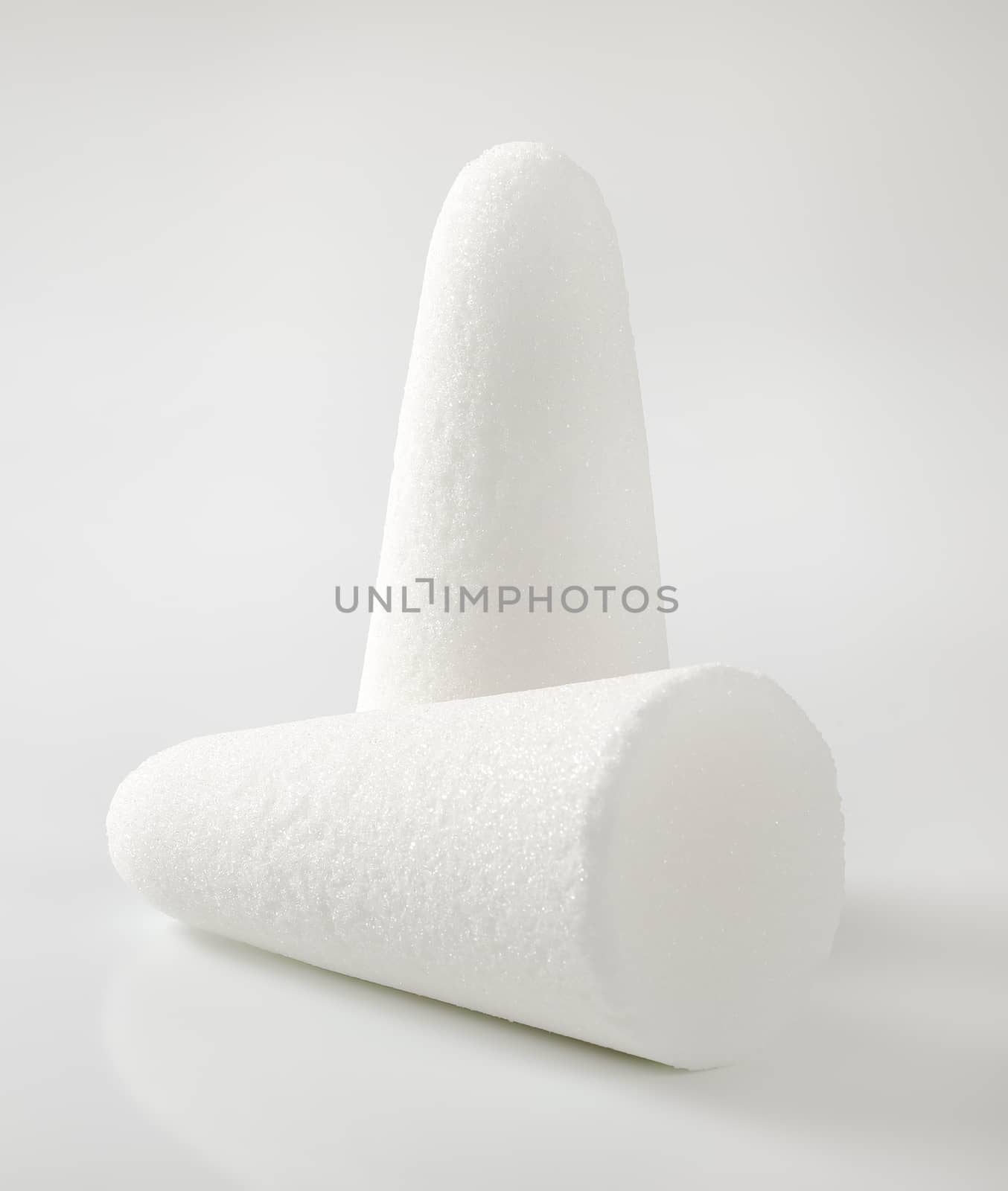 two white sugar loaves or cones on white background