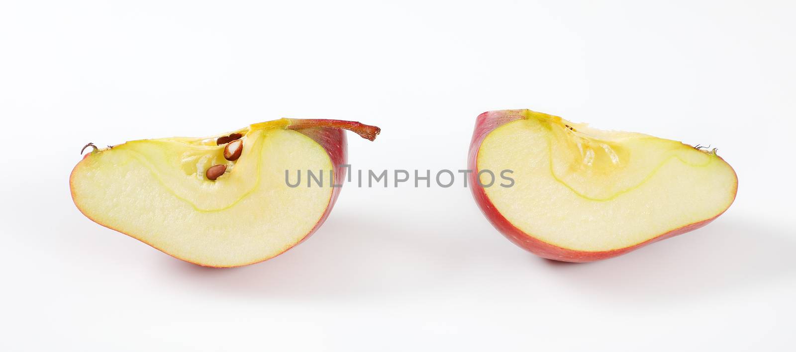 red apple wedges on white background