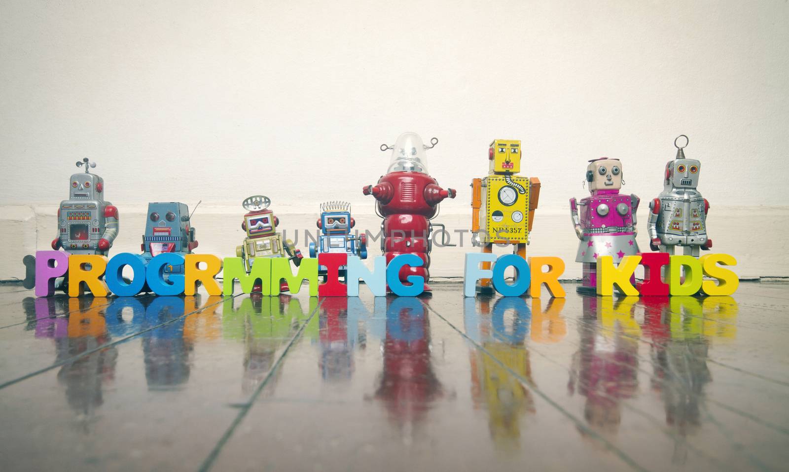 PROGRAMMING FOR KIDS with wooden letters and retro robots on a w by davincidig