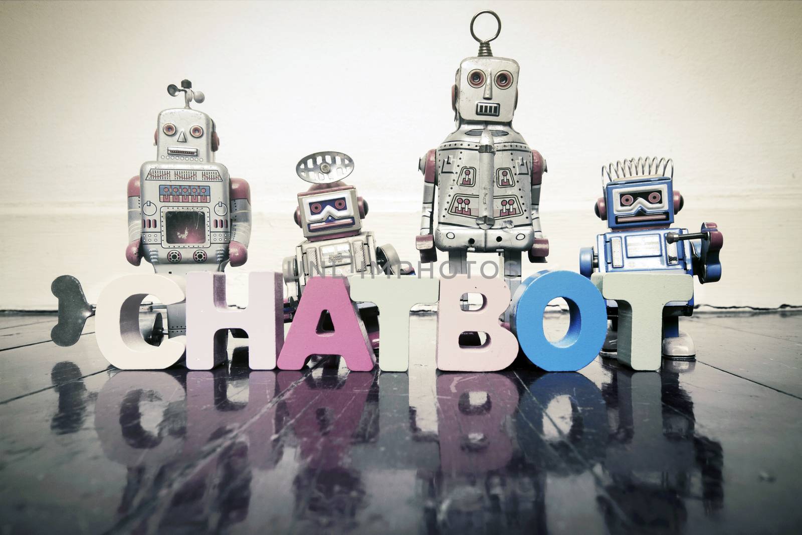 the word  CHAT BOT with wooden letters and retro toy robots  on  by davincidig