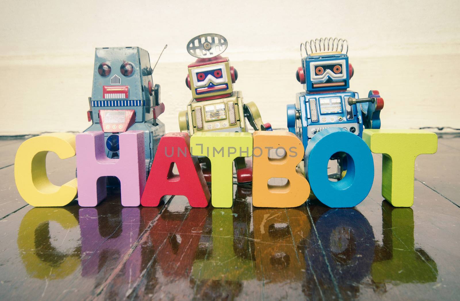 the word  CHAT BOT with wooden letters and retro toy robots  on  by davincidig