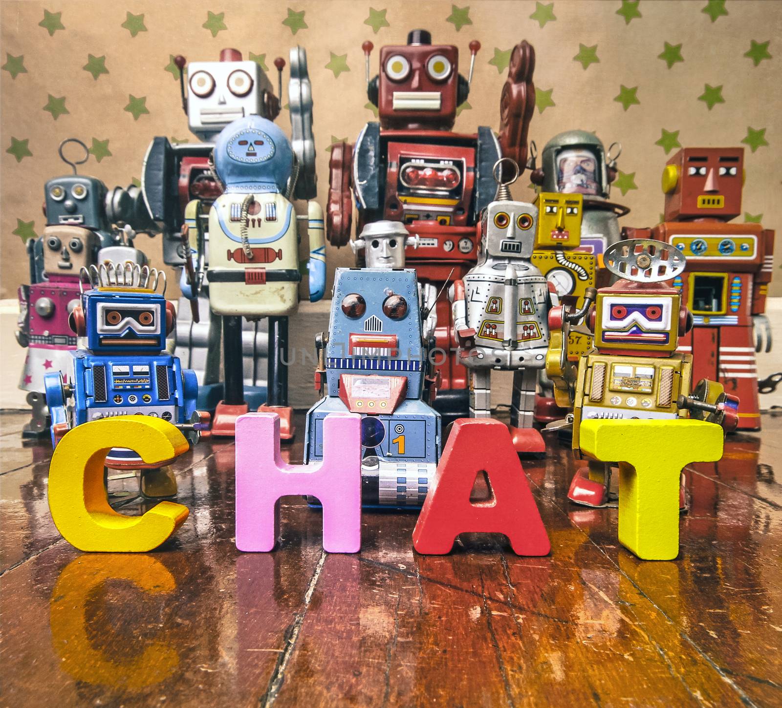 Chat Bot with wooden letters with retro robot toys on old woden floor 