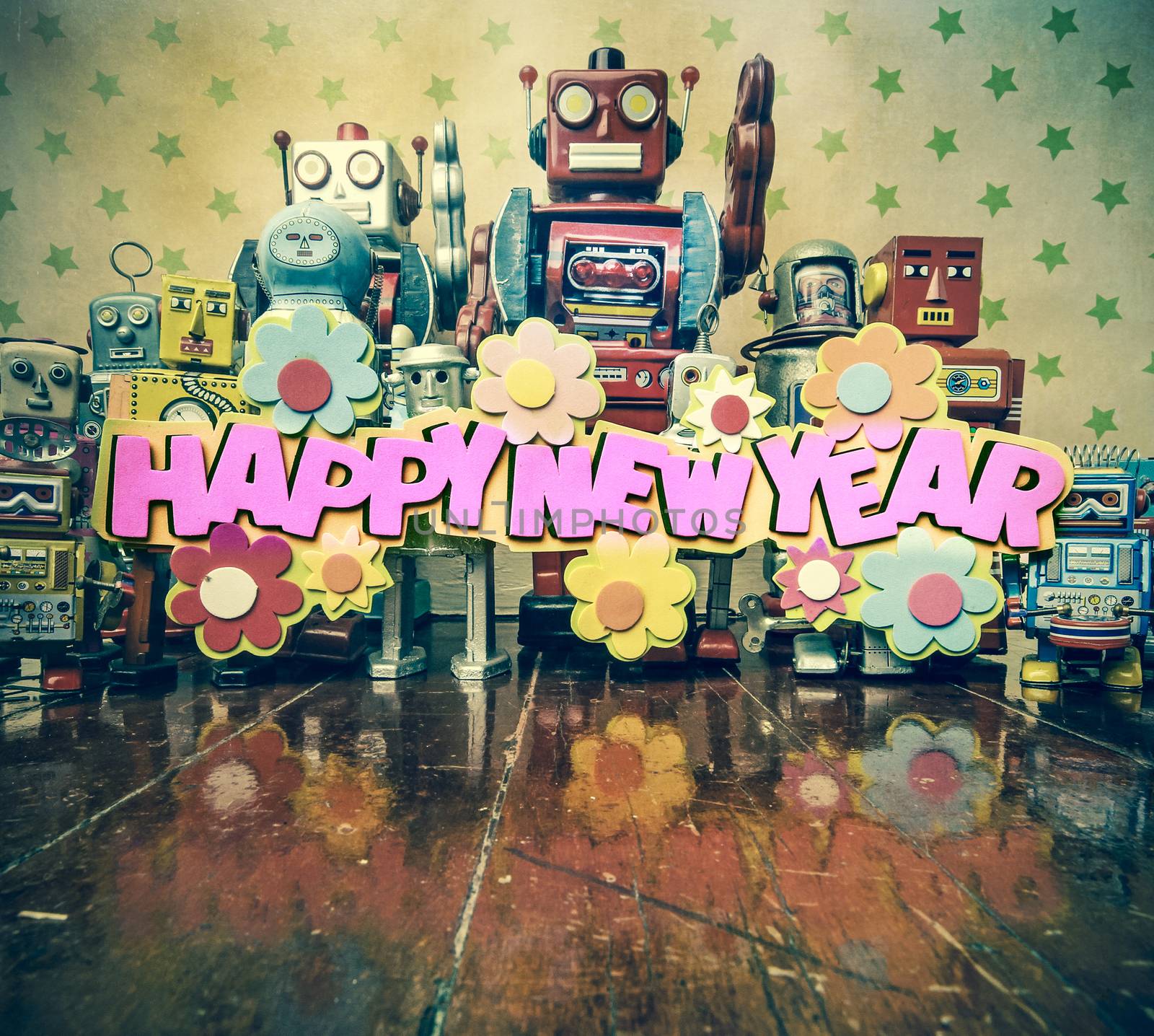 happy new year  text with vintage robots on old wooden floor