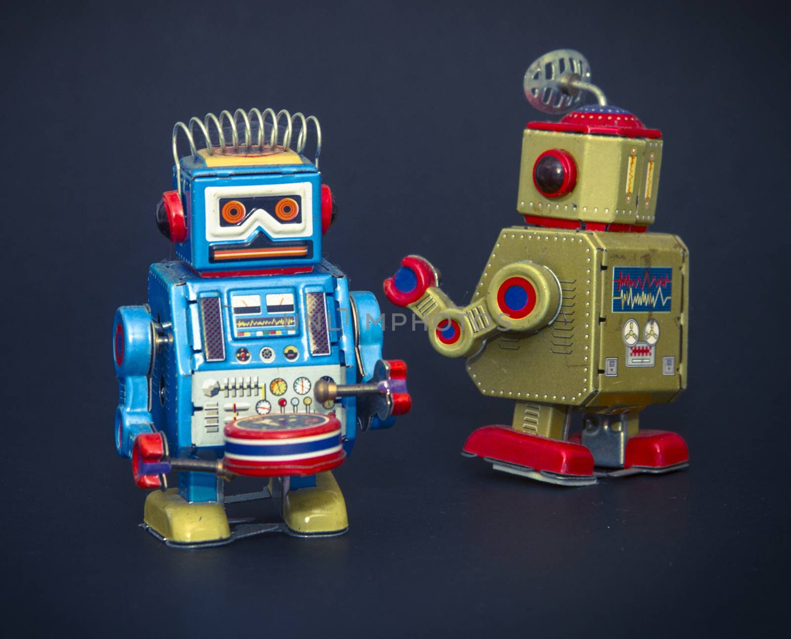 two retro robot toys on black 