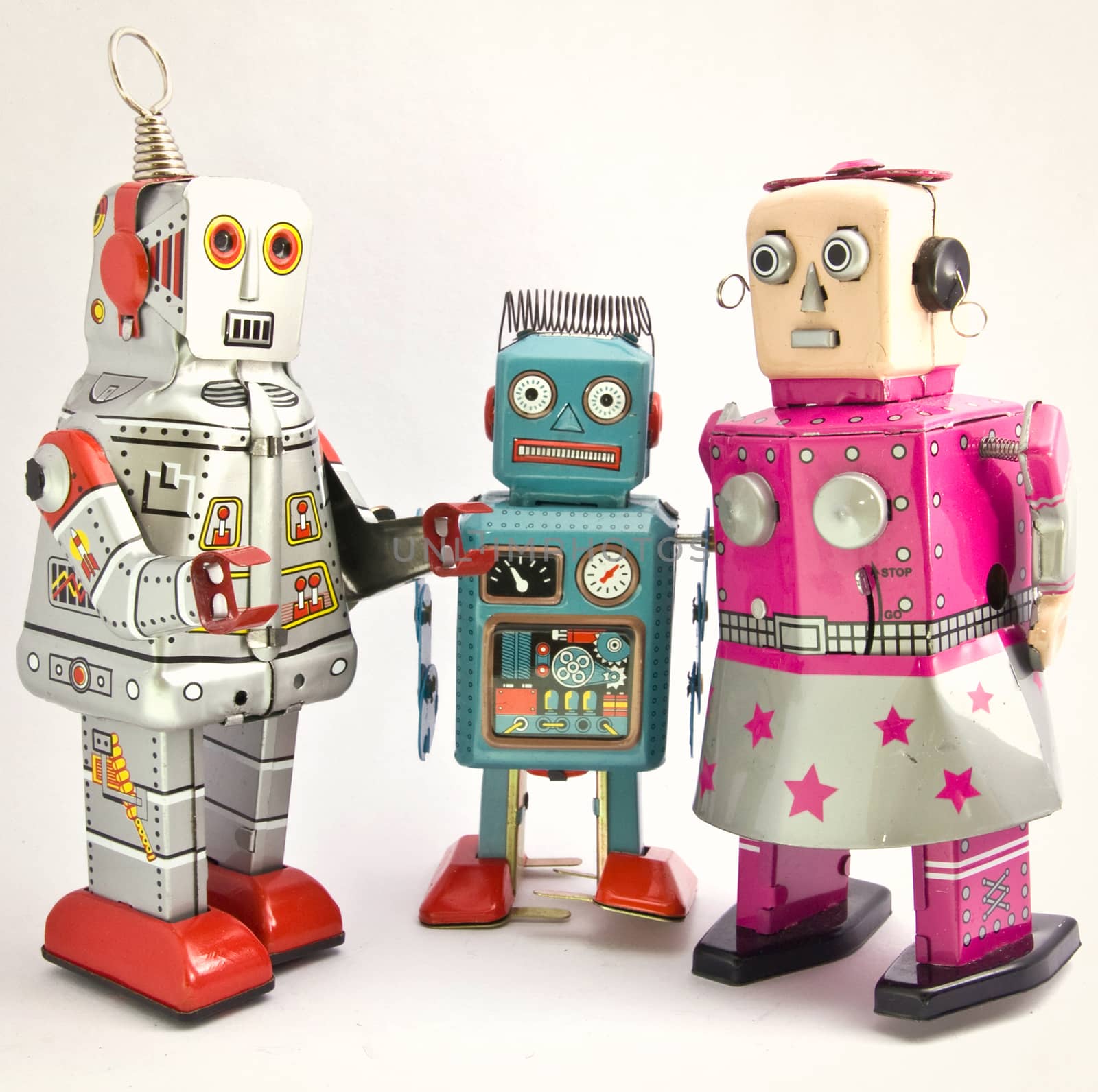 three retro toy robots together  on white 