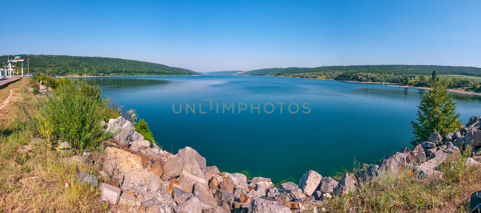 Deep blue lake against the backdrop of gently sloping green ridges by Adamchuk