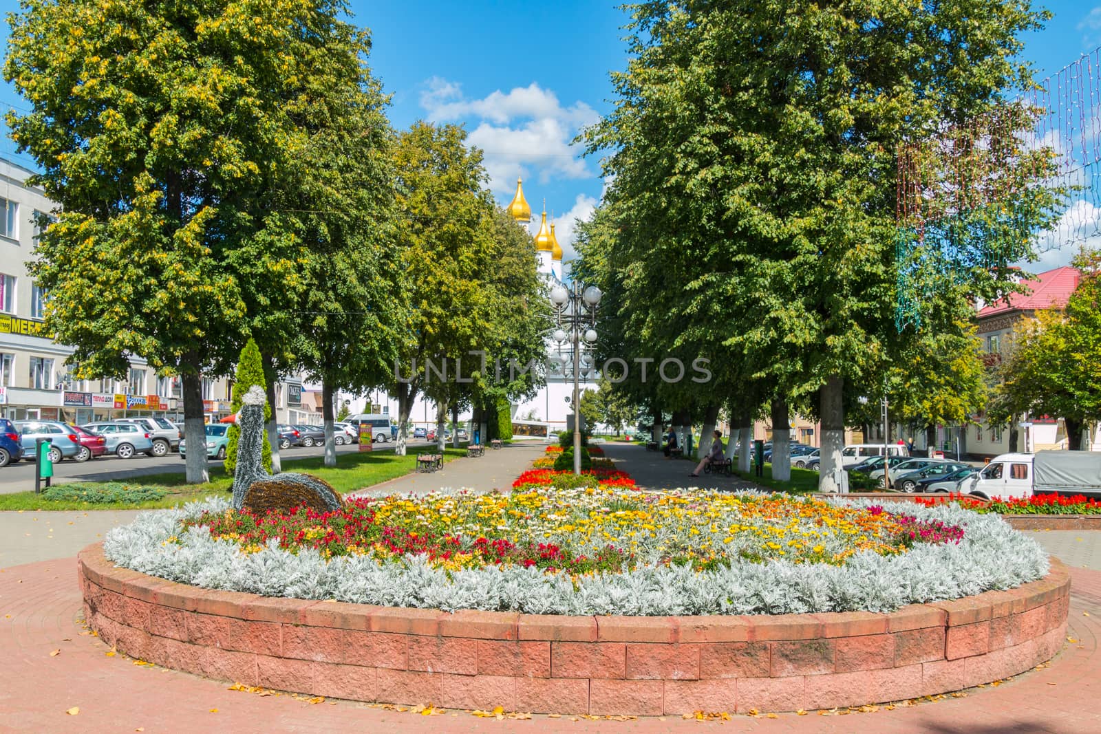 beautiful flowerbed with flowers in the alley in the center of the city