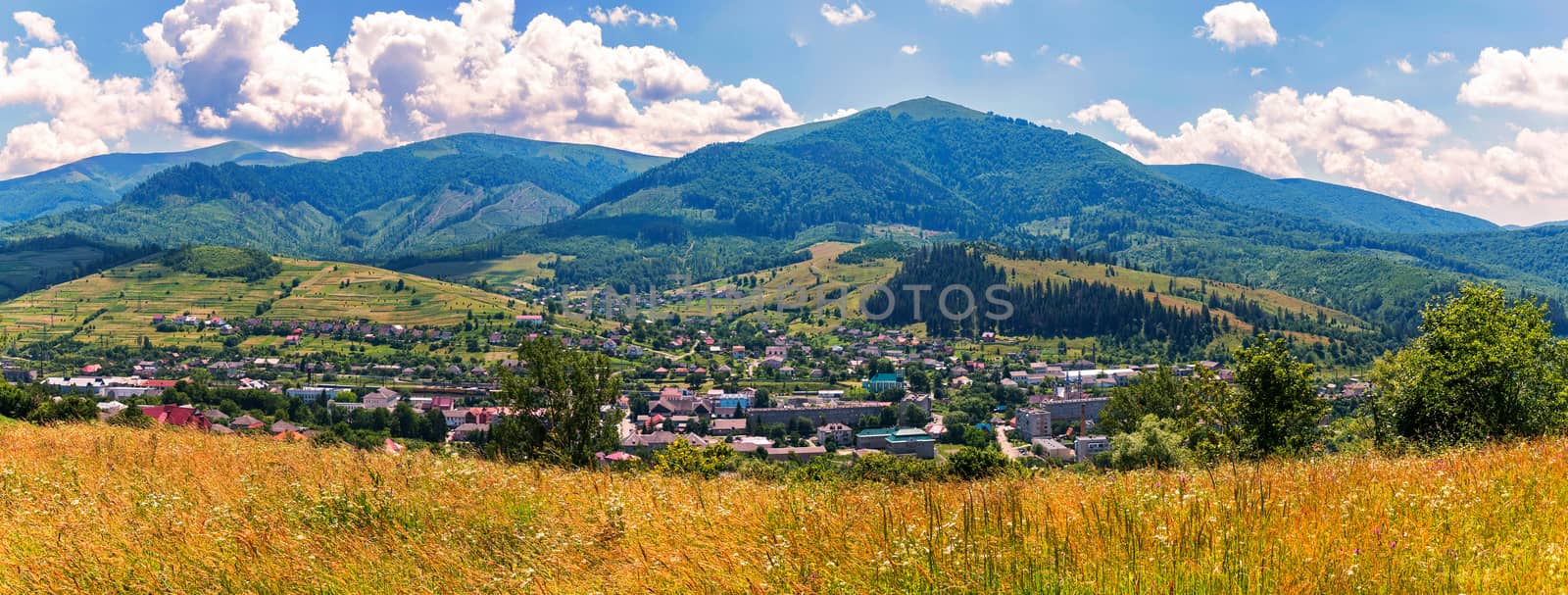The city is located in a valley under the green mountains. The gold of ripe herbs attracts its beauty