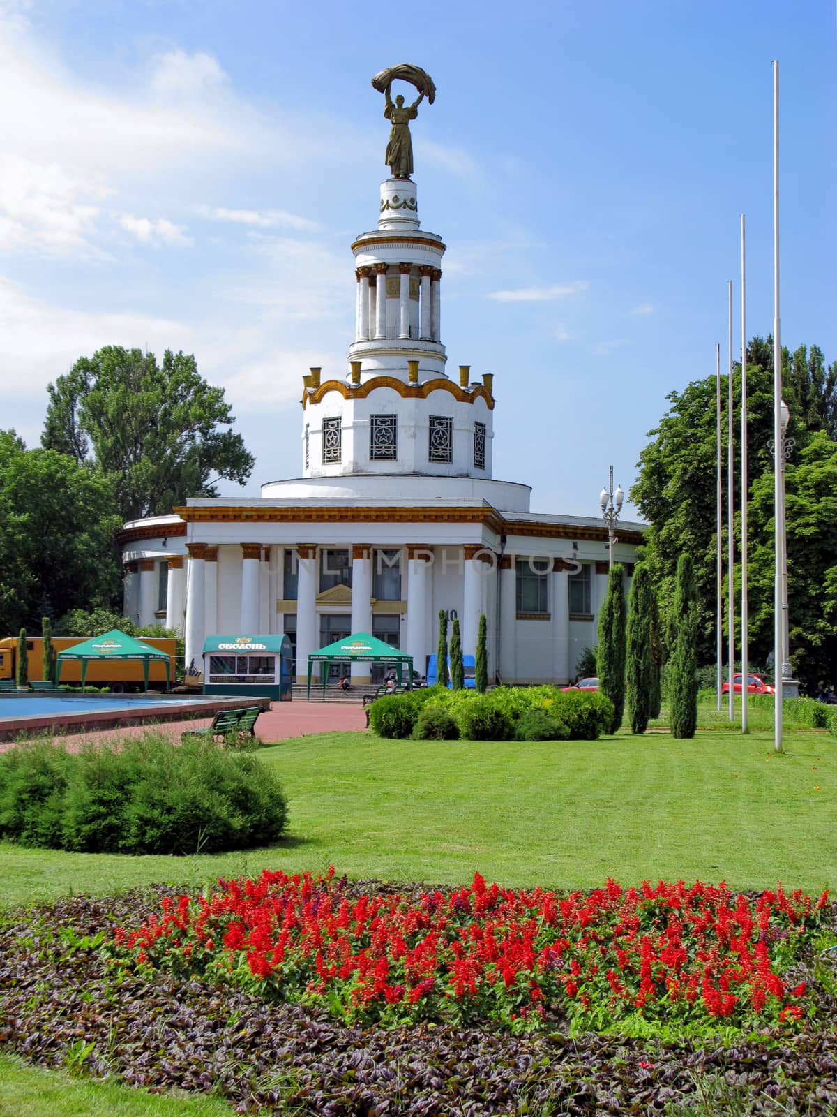 an excellent religious construction on the background of a green well-groomed lawn with flowers