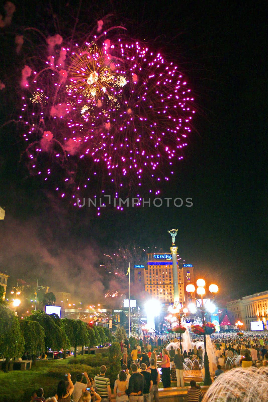 bright pink lights of beautiful fireworks in the city's night sky on Independence Square. Kiev. Ukraine
