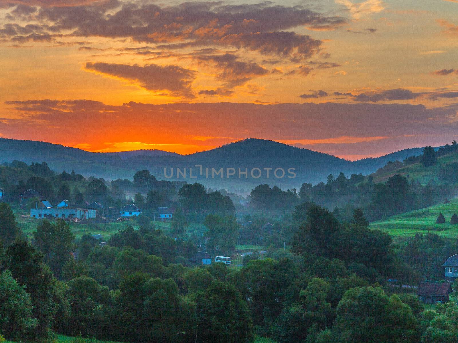 Picturesque pink sunset against the background of high green mountain ranges