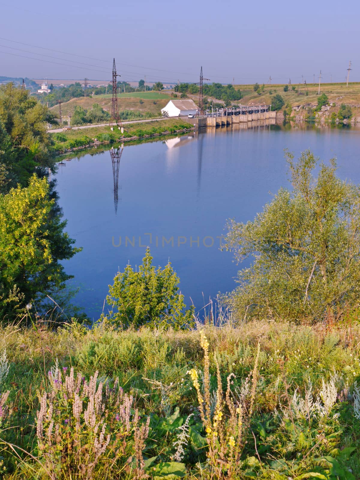 a colorful little pond and a quiet road running along it