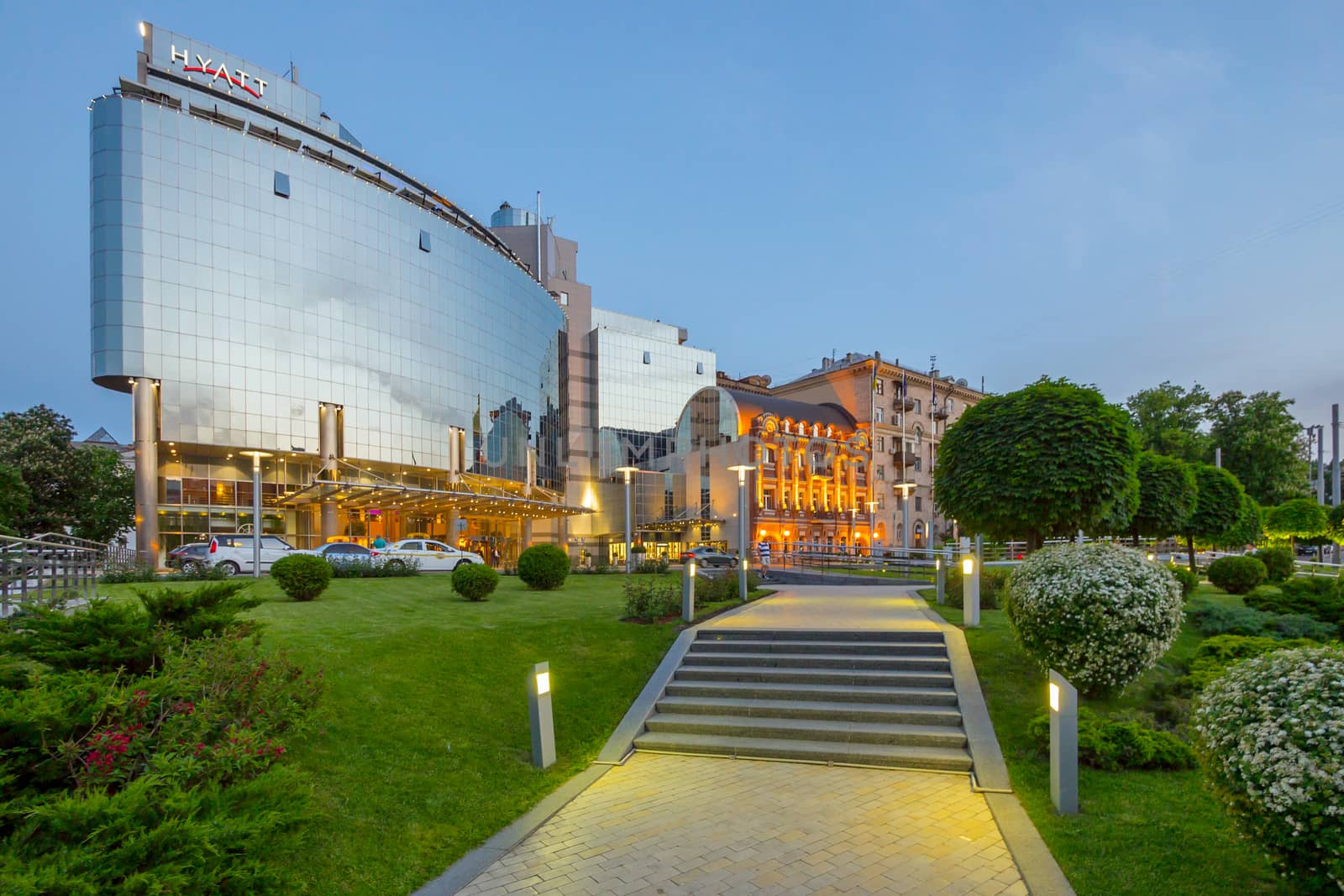 Stone steps leading to a beautiful modern hotel against the background of the evening sky