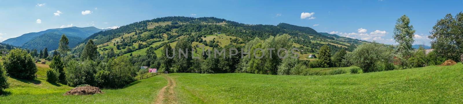 panorama to the path leading to houses and mountains