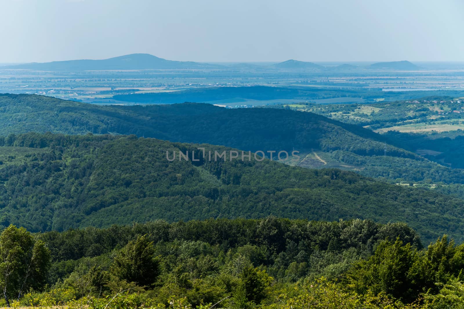 Green mountains and a hill in a blue haze. Beauty