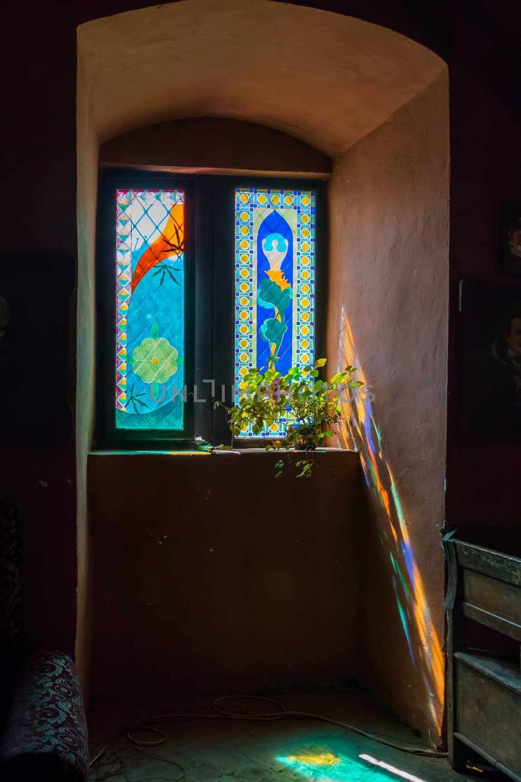 Window of the building with a remarkable stained glass, painted with interesting ornamental patterns