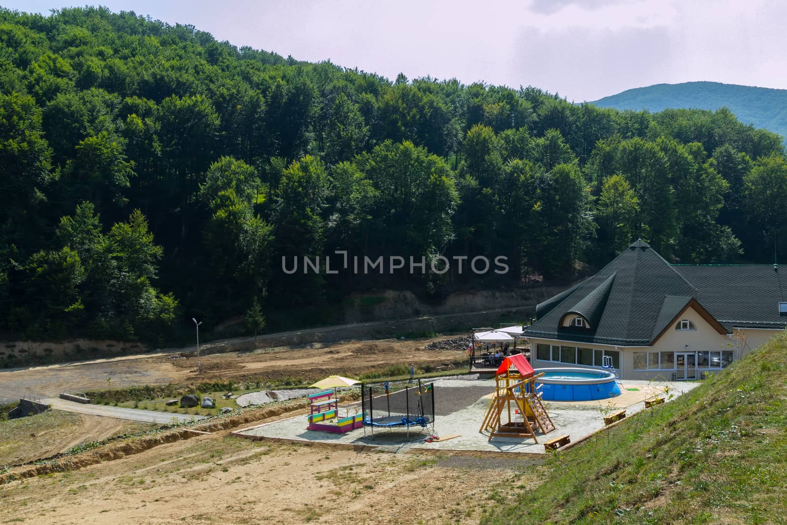 playground with pool in a country house with a forest in the background